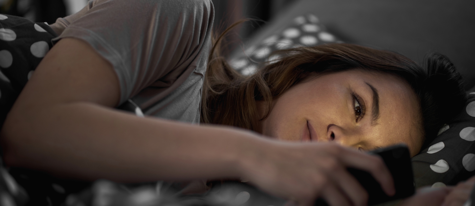 Woman in Bed With Phone