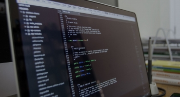 A laptop featuring a code editor and lines of code